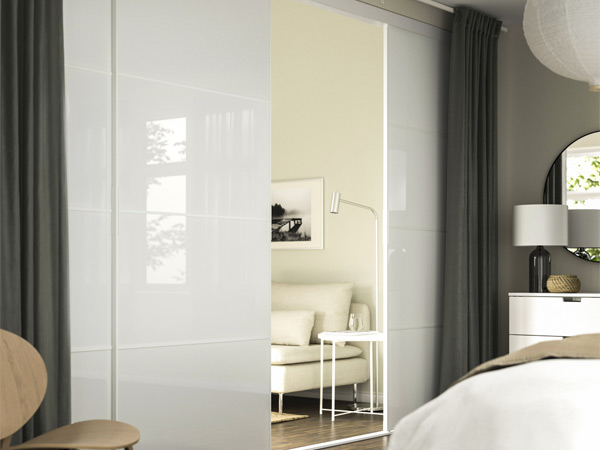 Glossy white sliding doors in modern bedroom