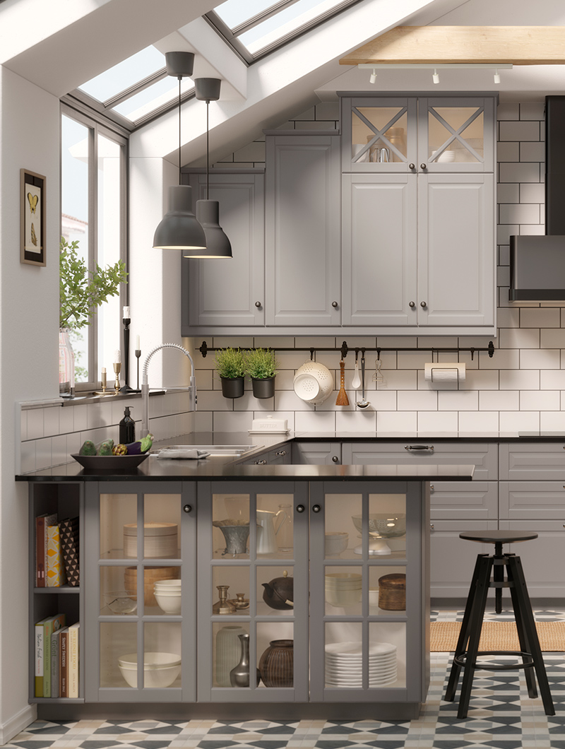 Kitchen in light gray colors, traditional, there is a kitchen island with glass doors underneath, there is a high black stool.