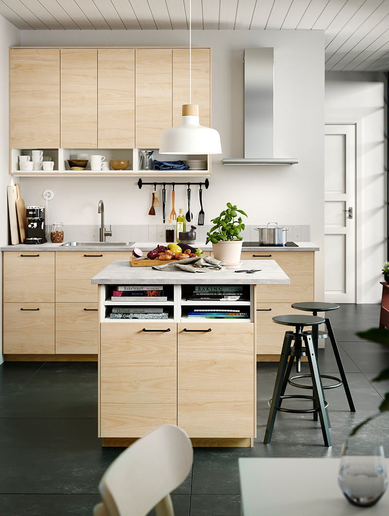 Spacious modern kitchen with light pine veneers, with a center shot of the kitchen island with light pine lower doors.
