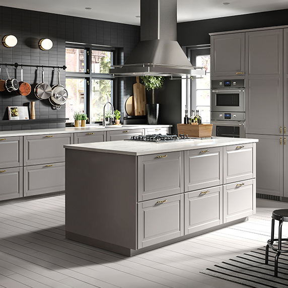 Large kitchen island, in a traditional setting with light girses colors.