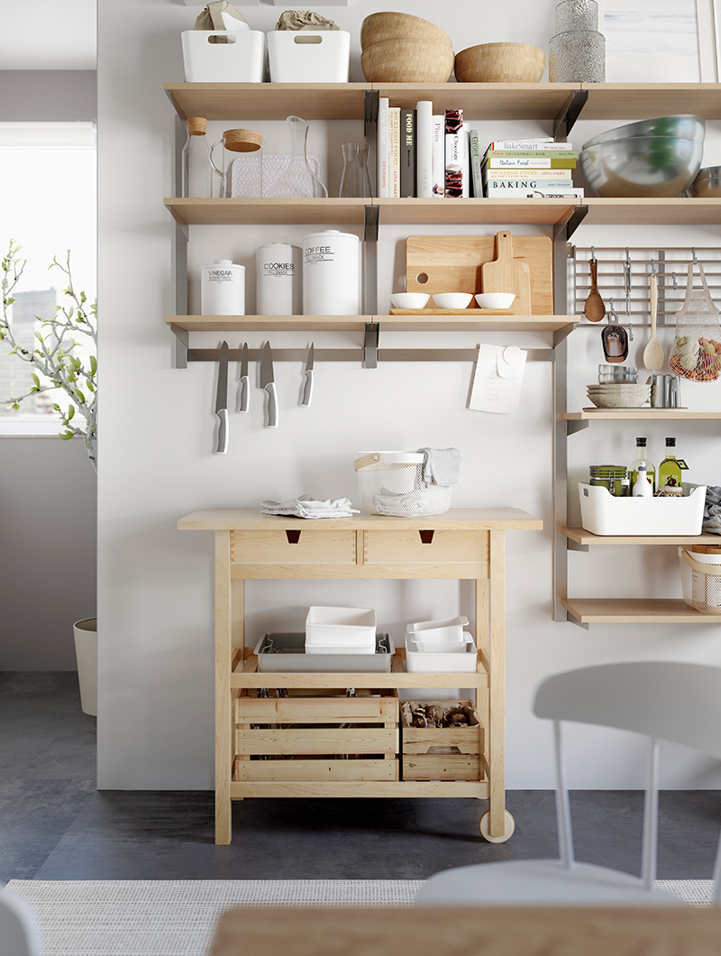 Wall lean kitchen trolley with several wall shelves with various utensils, pots and pans
