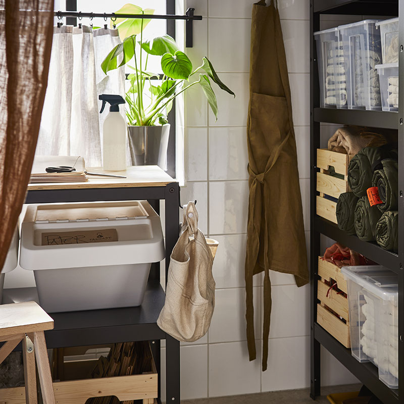 A storage room with a BROR workbench, a SORTERA recycling bin, and to the right, a BROR shelving unit with KNAGGLIG and SAMLA boxes.