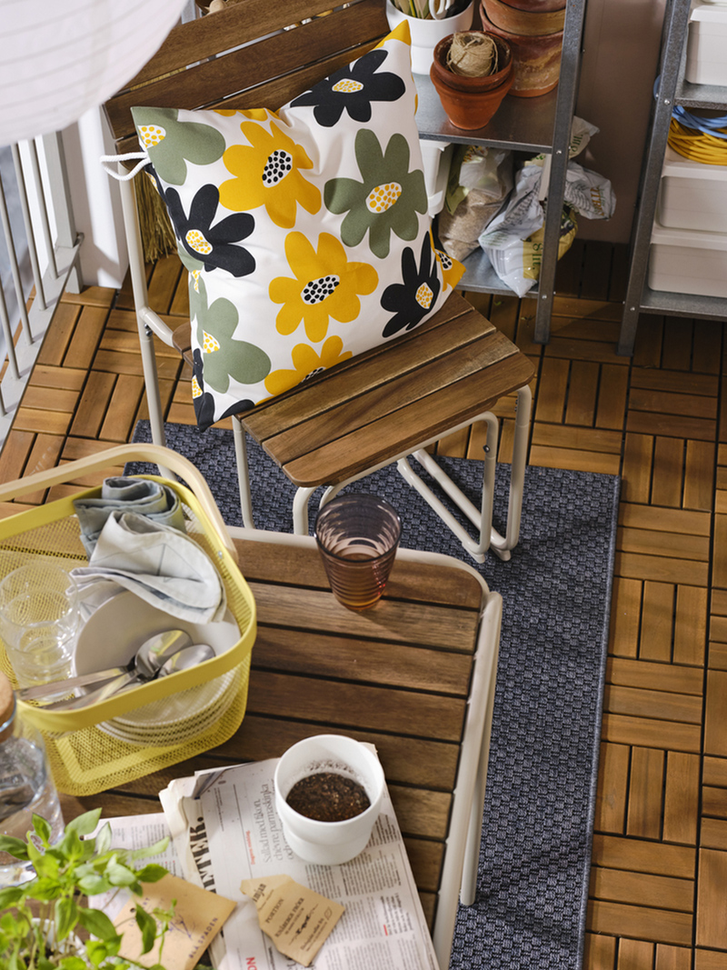  a table, two chairs and two footstools that you can use while dining al fresco