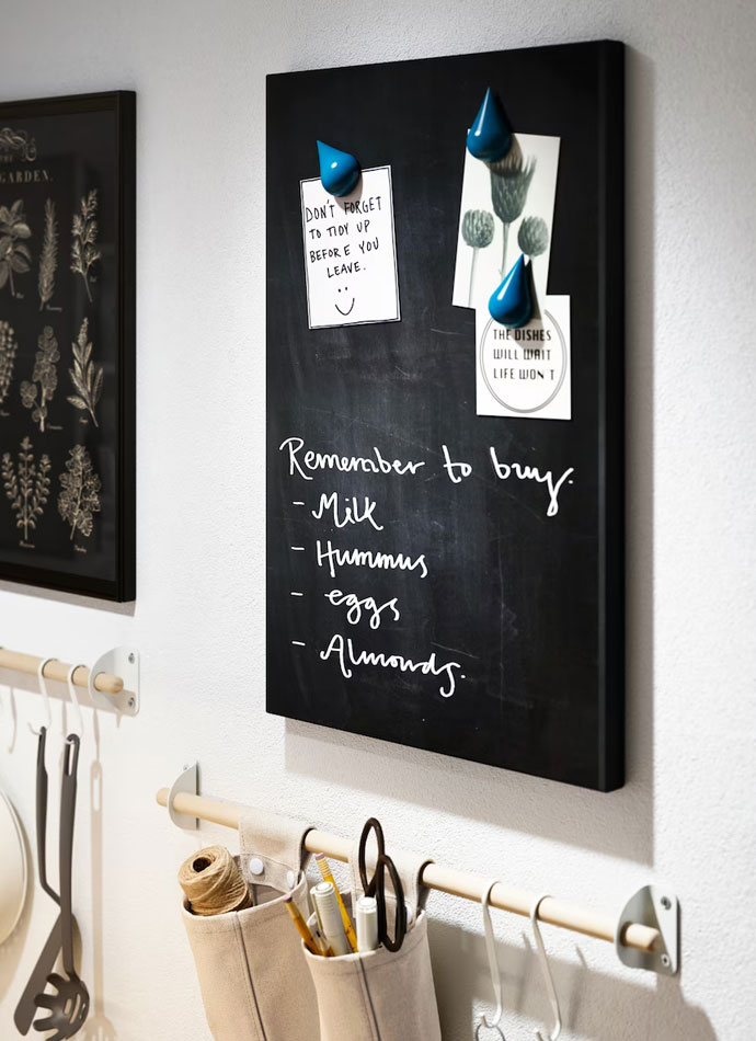 A blackboard with a list of ingredients and cooking utensils hung on the wall.