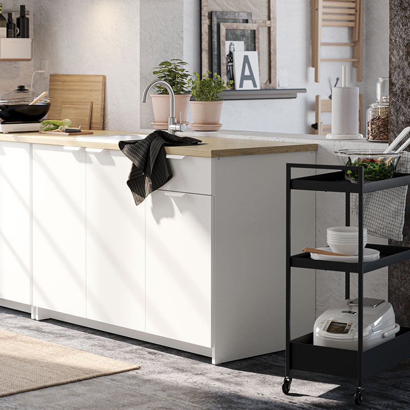 Small kitchen unit together with a black metal kitchen cart