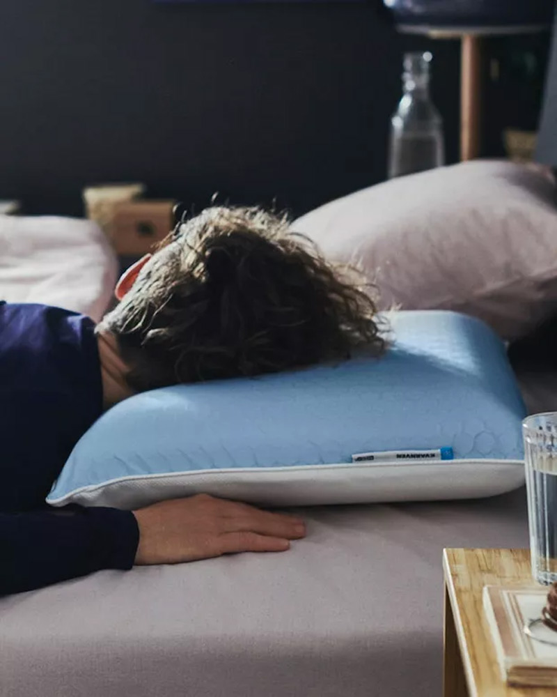 Person lying on a KVARNVEN ergonomic pillow.