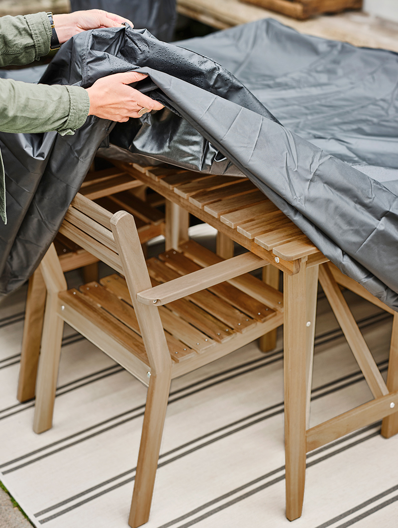 black plastic cover on top of outdoor tables and chairs