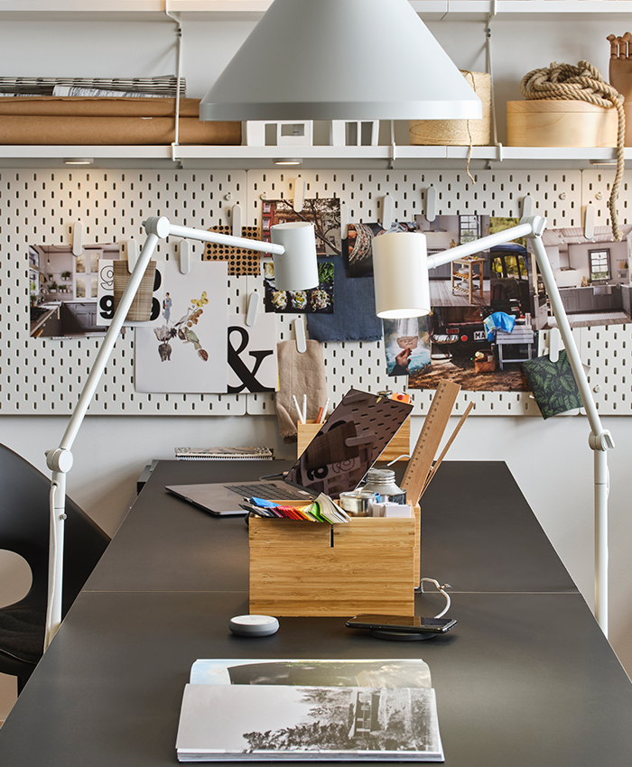 Office with LAGKAPTEN/KRILLE desks and ELDBERGET/MALSKÄR chairs, plus a DRAGAN bathroom set on top. For lighting, NYMÅNE floor lamps are used, and in the background, SKÅDIS pegboards.