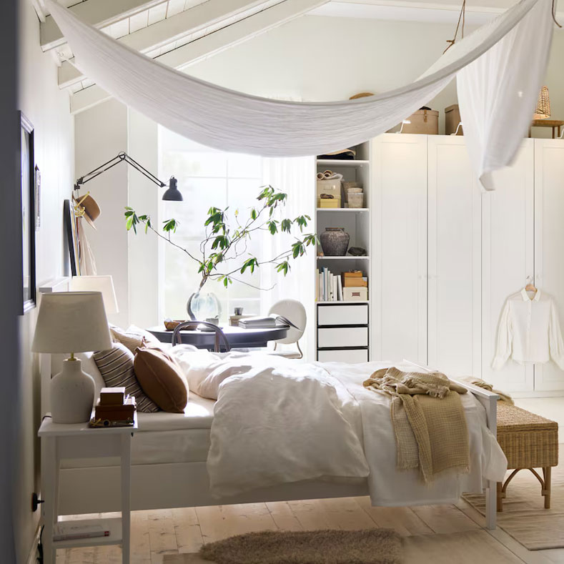 Scandinavian bedroom with cozy decor, warm lighting and minimalist furniture.