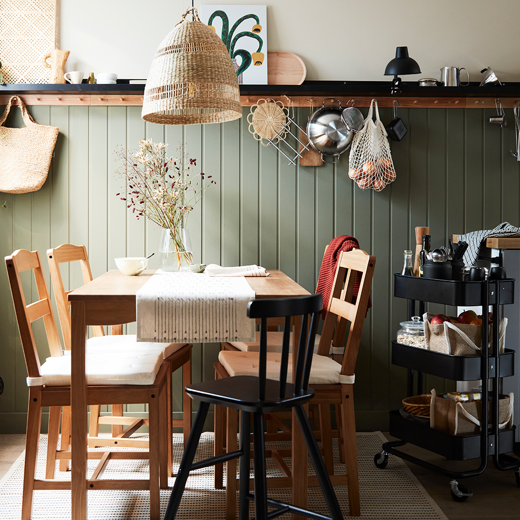 Vintage style dining room, oak style table and chairs, a large window, a woven hanging lamp, cozy and quiet atmosphere.