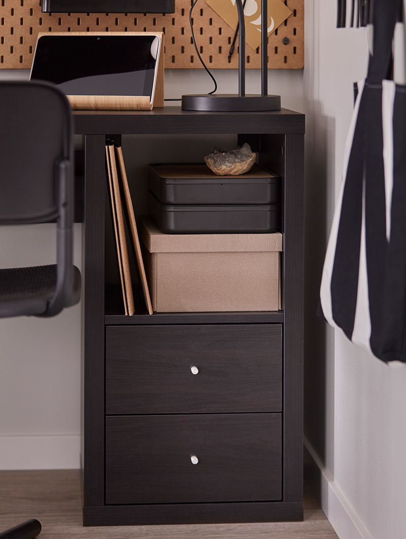  Dark office furniture with shelves and drawers. Laptop and decorative items. Study ambiance.
