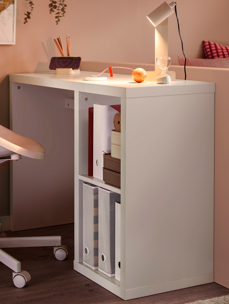  White desk with side shelf, lamp, and objects. Study and work ambiance.
