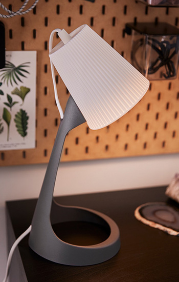  Gray desk lamp with white pleated shade. Geode accents, study ambiance.