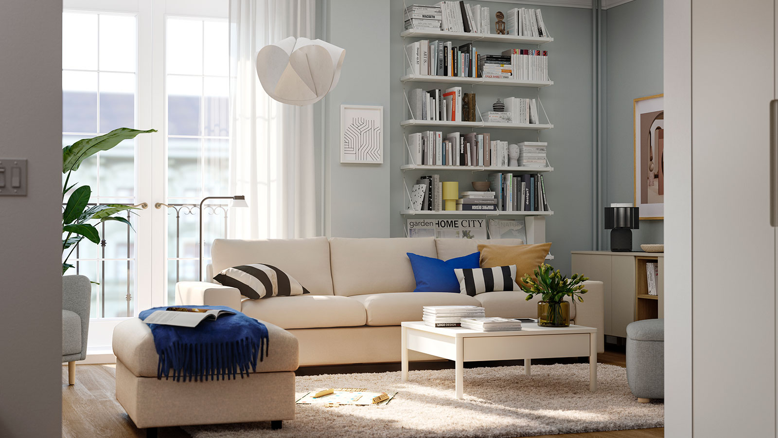 Modern living room with light sofa, bookshelves, coffee table and footrest