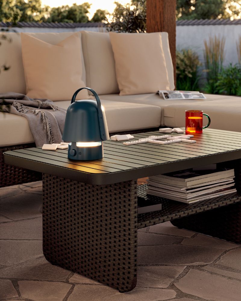 In the afternoon sun, a beige VITTSKÄR modular lounge seating with pillows and a grey HOLMVI throw, a dark grey coffee table.