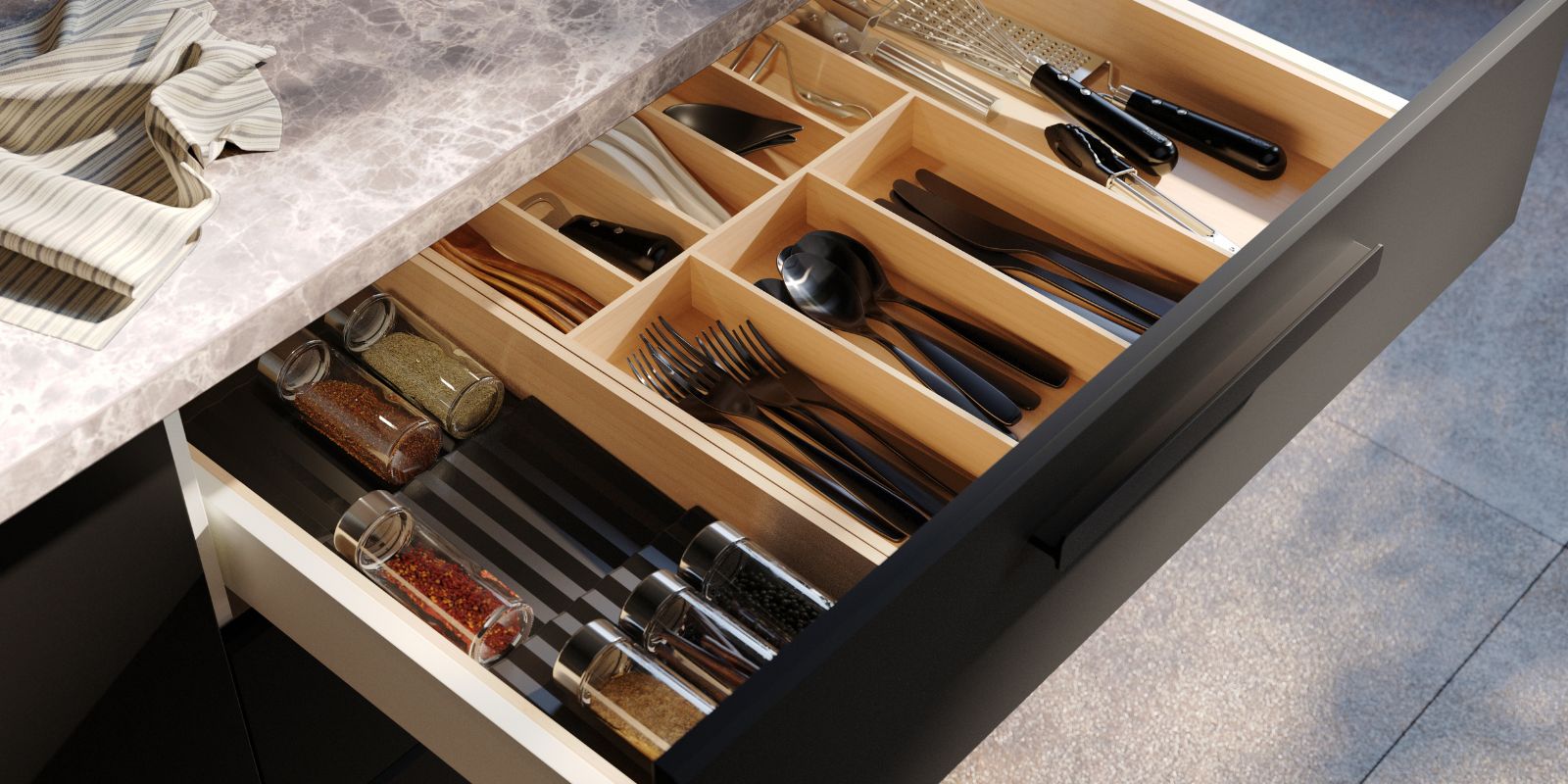 Organized kitchen drawer with TILLAGD cutlery, UPPDATERA utensil trays and VARDAGEN peeler neatly arranged.