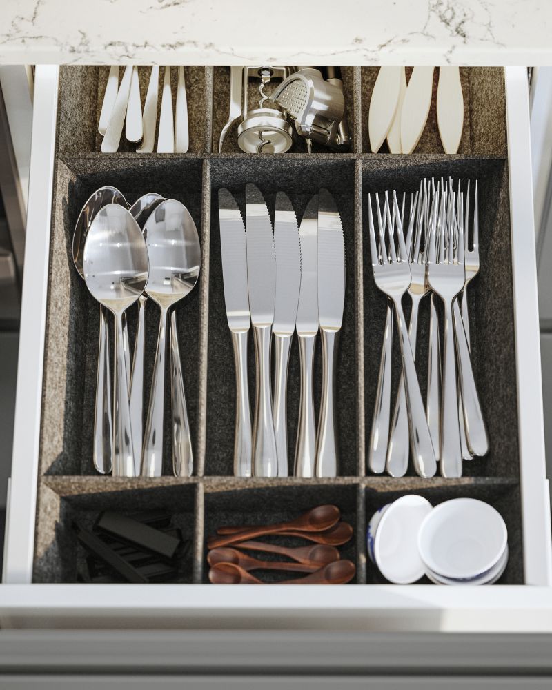 Organized kitchen drawer with DRAGON cutlery sets, UPPDATERA adjustable drawer organizers and IDEALISK corkscrew neatly arranged.