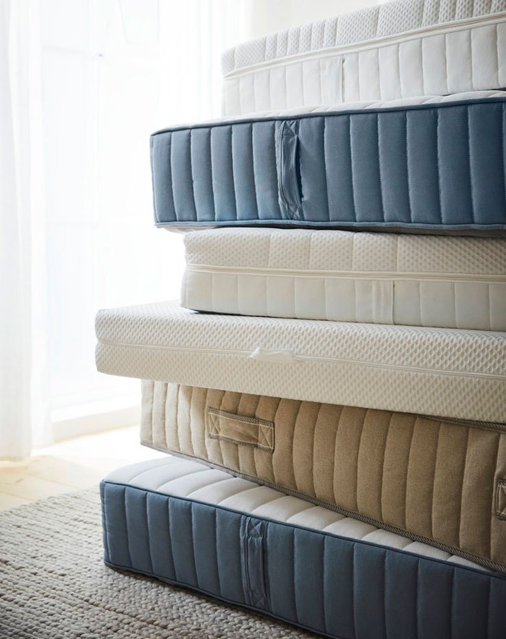 A pile of mattresses of different models and mattresses