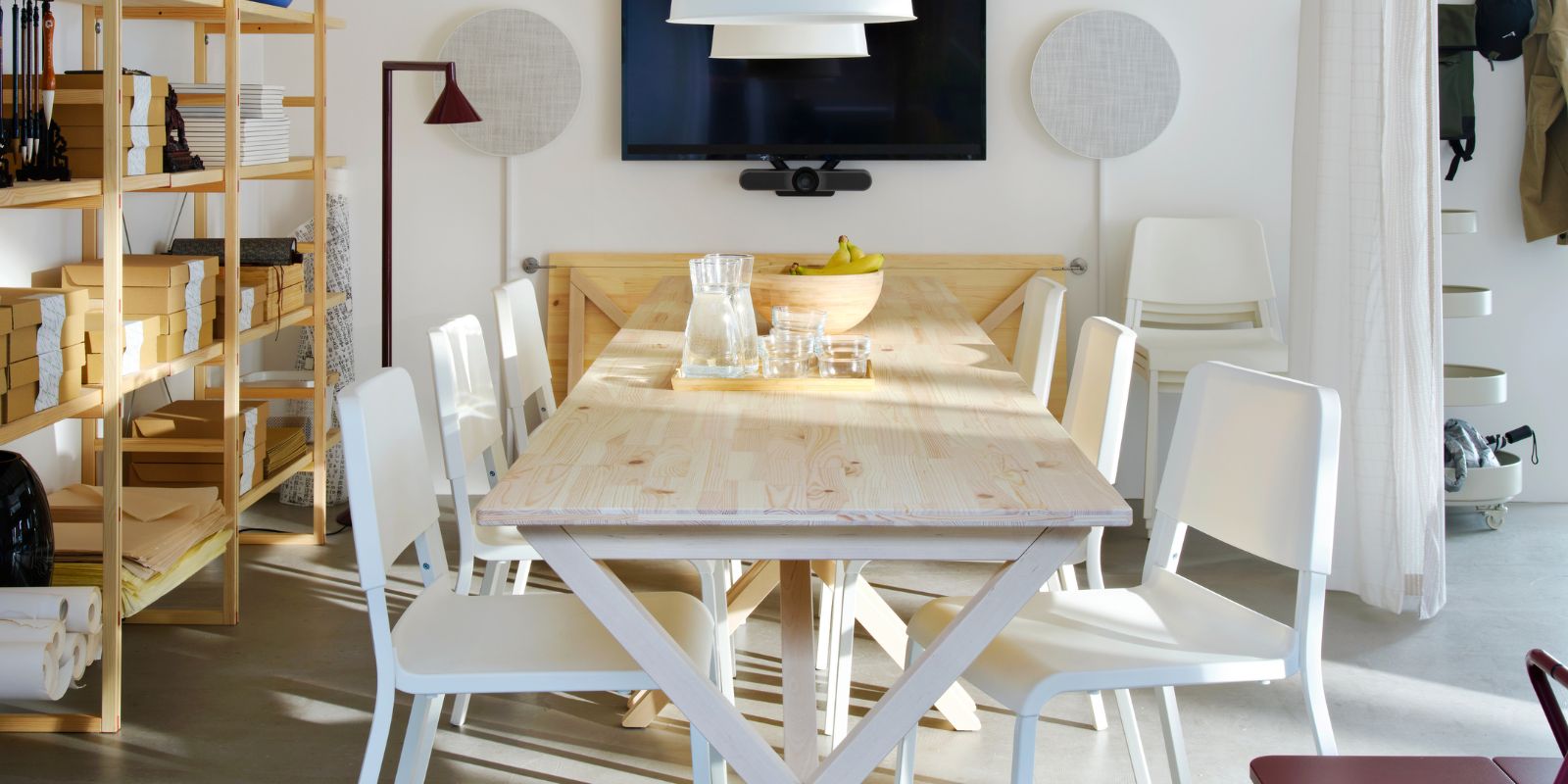 Modern meeting room with IKEA PS 2026 table, TEODORES chairs, BUNKEFLO lamps, SOLSKYDD speakers and IKEA PS 2026 shelving.