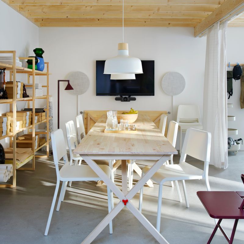 Modern meeting room with IKEA PS 2026 table, TEODORES chairs, BUNKEFLO lamps, SOLSKYDD speakers and IKEA PS 2026 shelving.