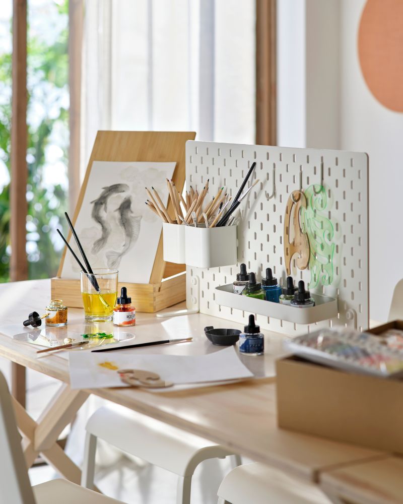 Creative office space with IKEA PS 2026 table, TEODORES chair, SKÅDIS board, SOLFÅGEL easels and SOLSKYDD speakers.