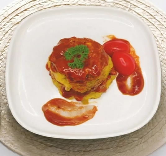 A round omelet or egg dish layered with tomato sauce and topped with parsley, served on a white square plate with two cherry tomatoes.