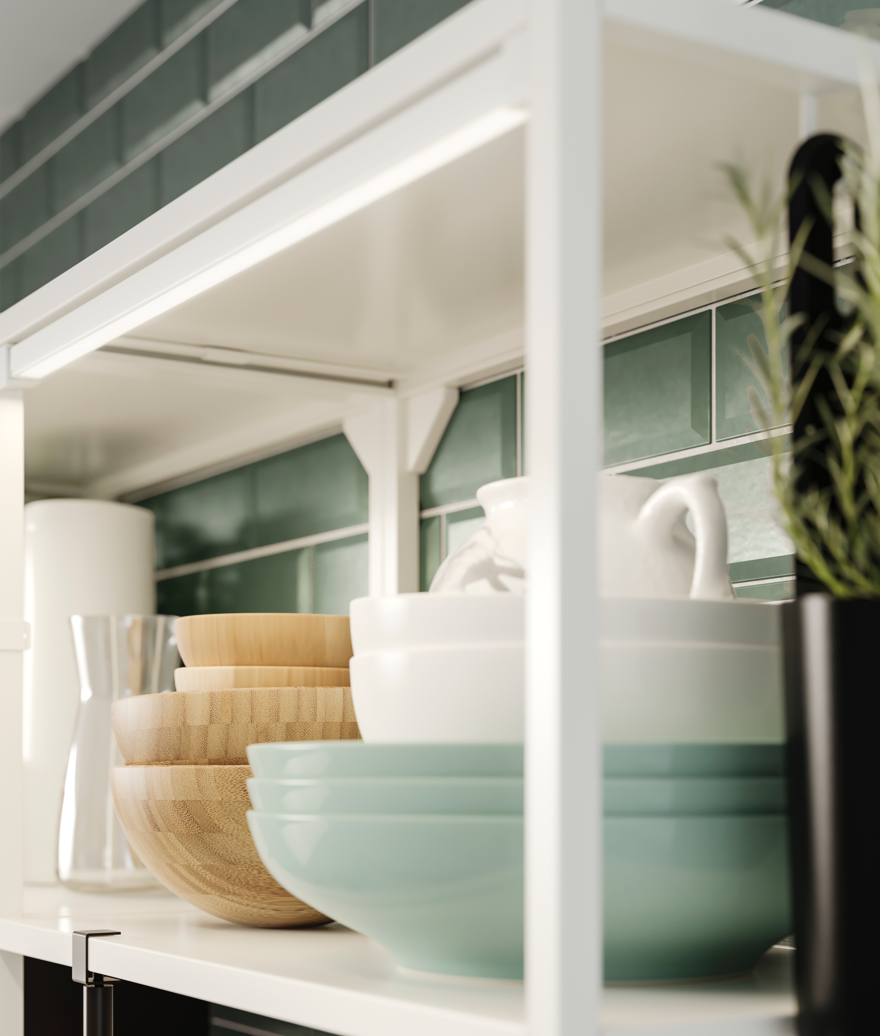 Kitchen shelving with neatly arranged plates, bowls, and pitchers.