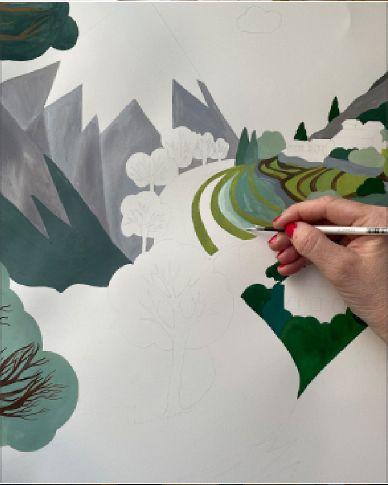 ALPTALL designer Malin Gyllensvaan hand-painting a Himalayan landscape for ALPTALL products in the children’s collection.