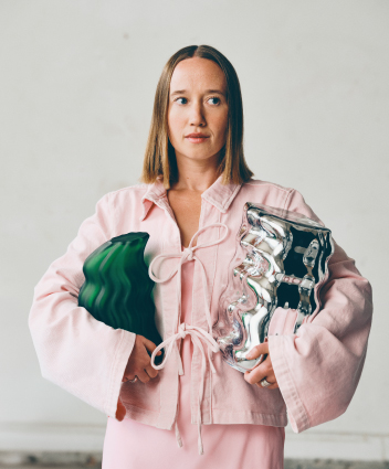 Person holding contemporary design pieces.