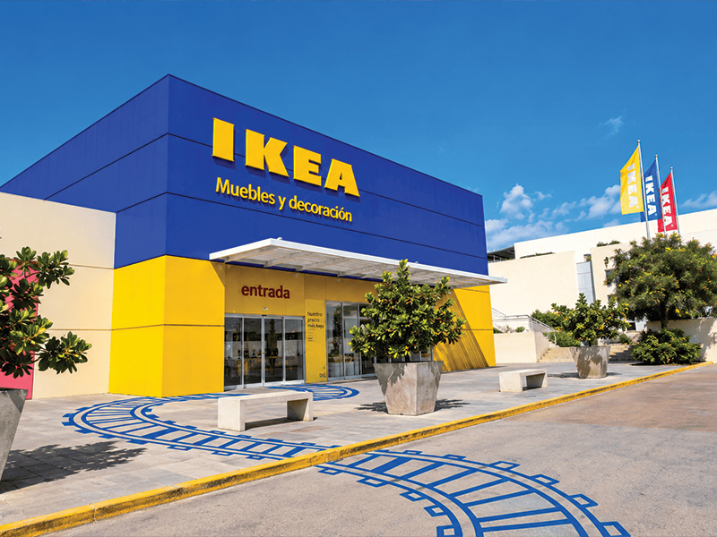 Exterior facade of a blue and yellow IKEA store with the main entrance.