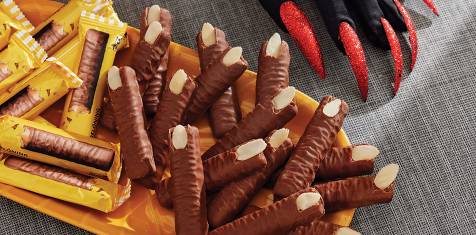Chocolate biscuits with almonds shaped like witch fingers for Halloween.