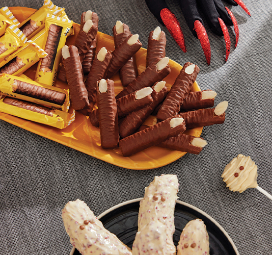 Chocolate biscuits with almonds shaped like witch fingers for Halloween.